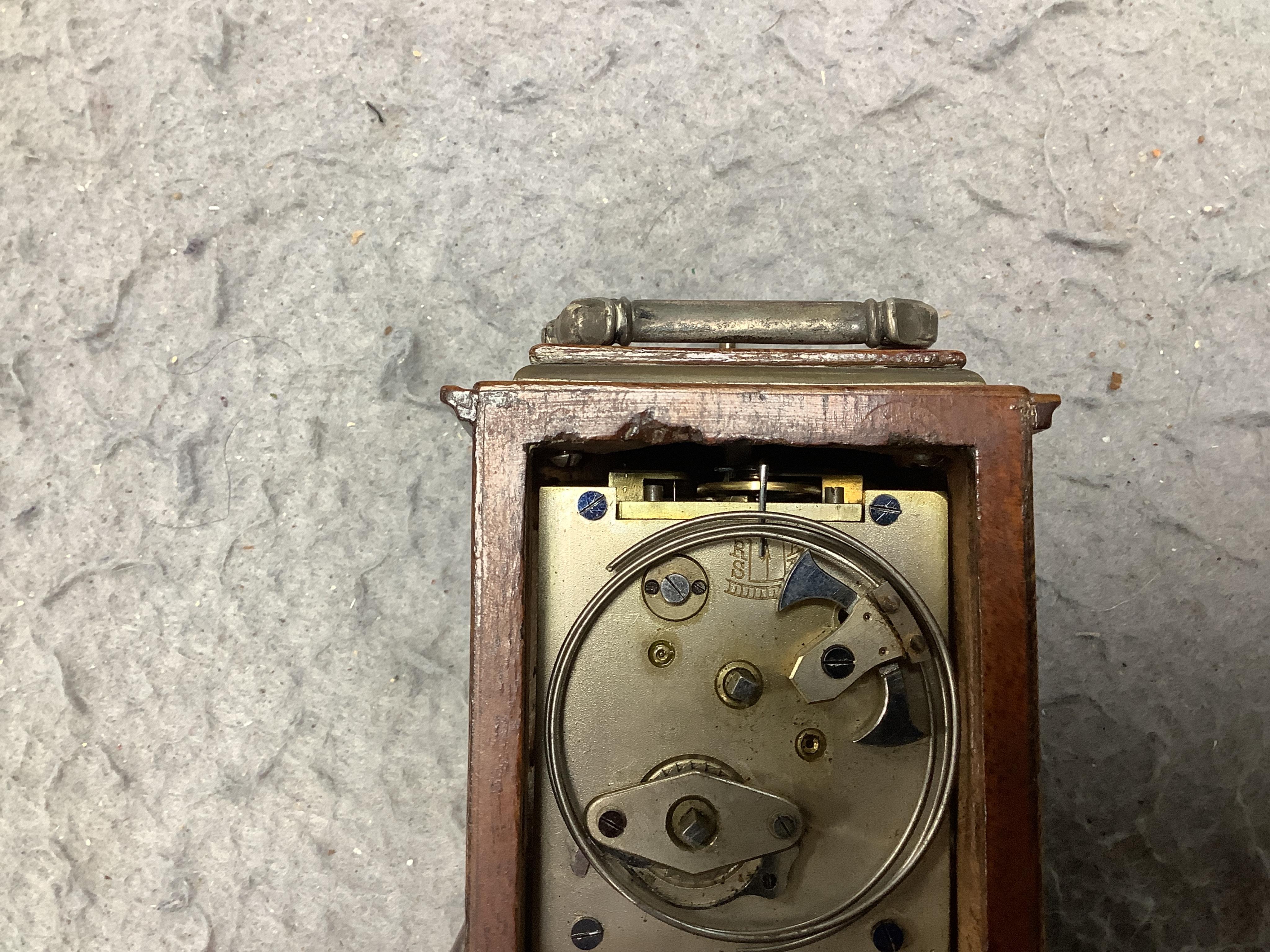 An early 20th century walnut miniature repeating carriage clock, with key, 8.5cm. Condition - fair, currently ticking